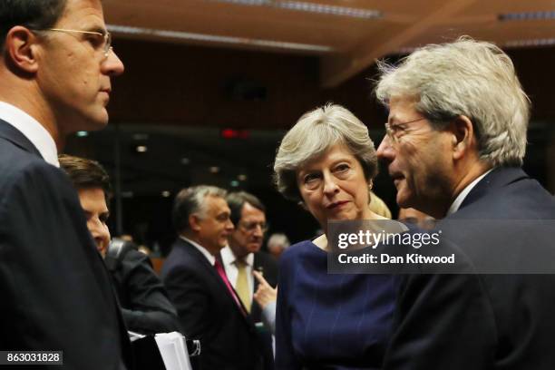 British Prime Minister Theresa May speaks with her counterparts ahead of a European Council Meeting at the Council of the European Union building on...