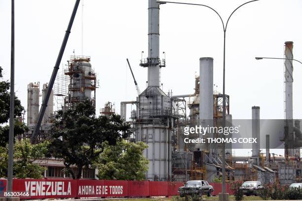 Cars drive pass in fornt of a oil refinery in the Venezuelan city of Moron on April 30, 2009. The petroleum sector dominates Venezuela's mixed...