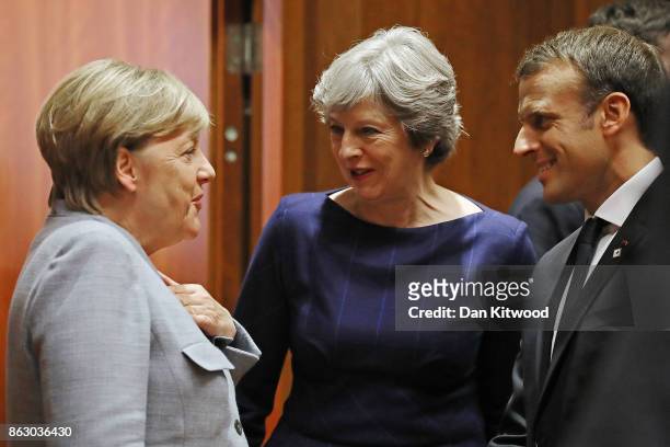 German Chancellor Angela Merkel, Britain's Prime Minister Theresa May and French President Emmanuel Macron arrive for a round table meeting on...