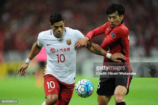 Hulk of Shanghai SIPG and Takuya Aoki of Urawa Red Diamonds compete for the ball during the AFC Champions League semi final second leg match between...