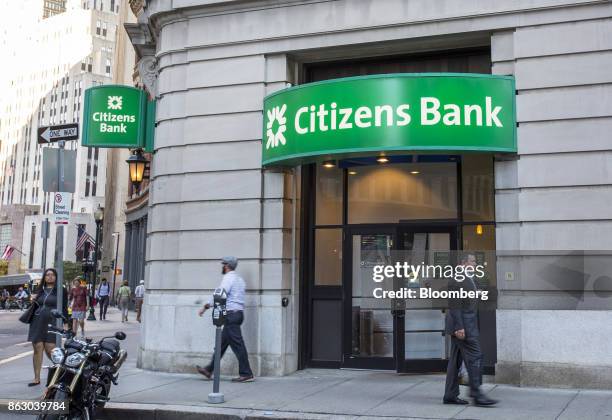 Pedestrians pass in front of a Citizens Financial Group Inc. Bank branch in downtown Boston, Massachusetts, U.S., on Tuesday, Oct. 10, 2017. Citizens...