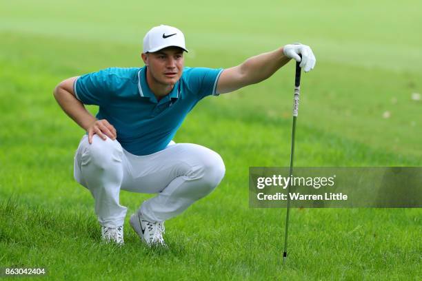 Oliver Fisher of England prepares to hit his second shot on the 18th hole during day one of the Andalucia Valderrama Masters at Real Club Valderrama...