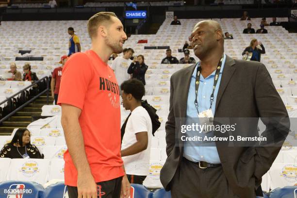 Former NBA player, Adonal Foyle talks with Ryan Anderson of the Houston Rockets before the game against the Golden State Warriors on October 17, 2017...