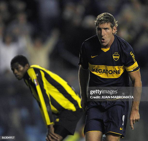 Argentina's Boca Juniors forward Martin Palermo celebrates his second goal next to Venezuela's Deportivo Tachira defender Jose Granados during their...