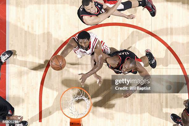 Ron Artest of the Houston Rockets goes to the basket against Travis Outlaw of the Portland Trail Blazers in Game Four of the Western Conference...