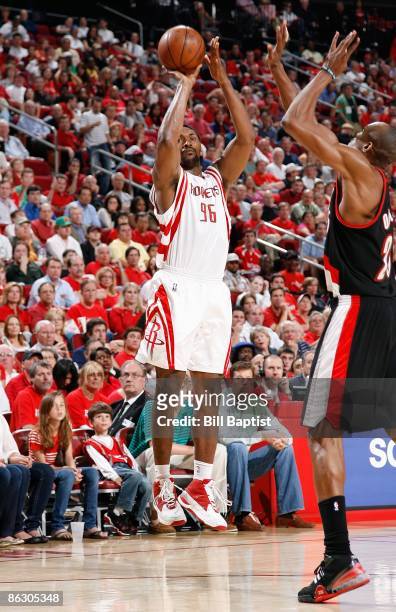 Ron Artest of the Houston Rockets shoots over Travis Outlaw of the Portland Trail Blazers in Game Four of the Western Conference Quarterfinals during...