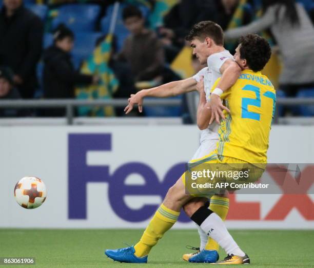 Maccabi Tel Aviv's forward from Iceland Vidar Orn Kjartansson and Astana's defender from Kazakhstan Yuri Logvinenko vie for the ball during the UEFA...