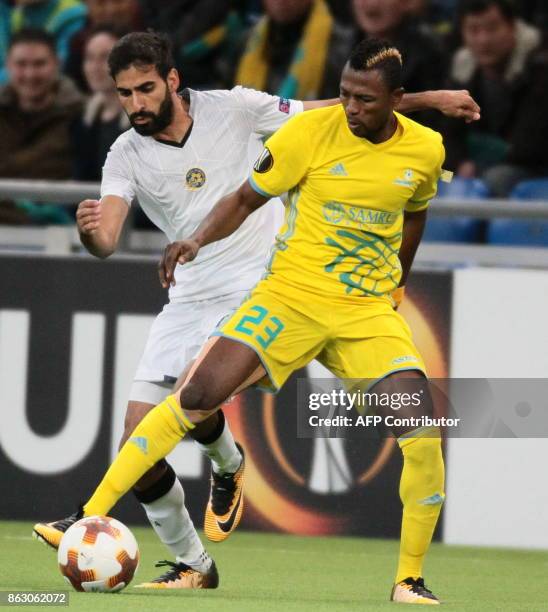 Maccabi Tel Aviv's defender from Israel Ofir Davidazde and Astana's forward from Ghana Patrick Twumasi vie for the ball during the UEFA Europa League...