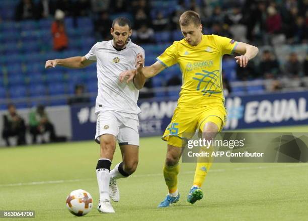 Maccabi Tel Aviv's defender from Israel Yuval Shpungin and Astana's forward from Kazakhstan Roman Murtazayev vie for the ball during the UEFA Europa...