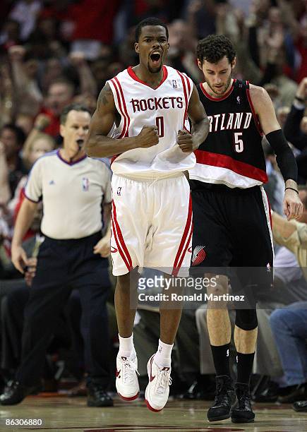 Guard Aaron Brooks of the Houston Rockets reacts after making a three-point shot in front of Rudy Fernandez of the Portland Trail Blazers in Game Six...
