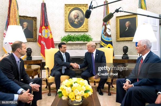 President Donald Trump shakes hands with Governor Ricardo Rossello of Puerto Rico during a meeting in the Oval Office at the White House on October...