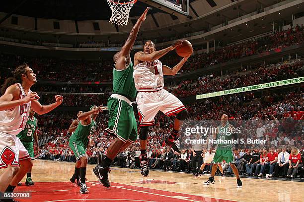 Derrick Rose of the Chicago Bulls looks to pass past Glenn Davis of the Boston Celtics during Game Six of the Eastern Conference Quarterfinals as...