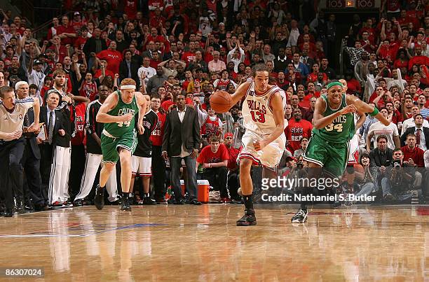 Joakim Noah of the Chicago Bulls steals the ball from Paul Pierce of the Boston Celtics in the third overtime of Game Six of the Eastern Conference...