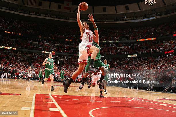 Joakim Noah of the Chicago Bulls is fouled by Paul Pierce of the Boston Celtics after stealing the ball in the third overtime of Game Six of the...