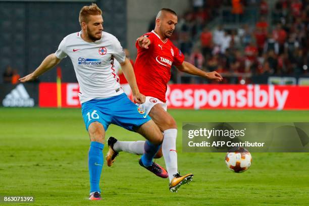 Hapoel's Israeli forward Ben Sahar vies for the ball with Steaua's Serbian defender Bobgan Planic during the UEFA Europa League Group G football...