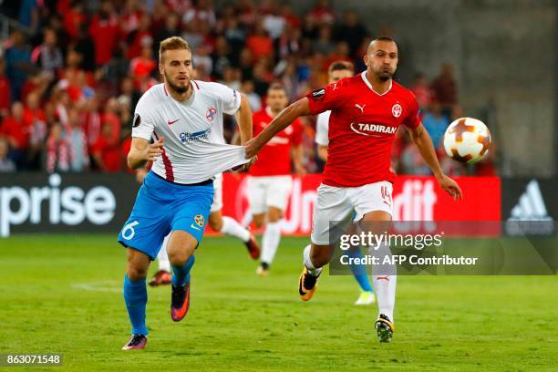 Hapoel's Israeli forward Ben Sahar vies for the ball with Steaua's Serbian defender Bobgan Planic during the UEFA Europa League Group G football...