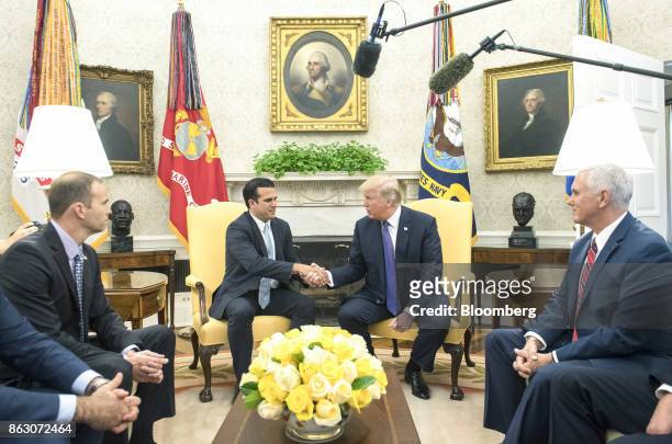 Vice President Mike Pence, right, and Brock Long, administrator of the Federal Emergency Management Agency , left, sit as U.S. President Donald...