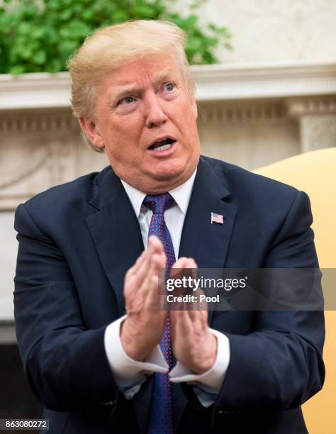 President Donald Trump speaks to the media during a meeting with Governor Ricardo Rossello of Puerto Rico in the Oval Office at the White House on...