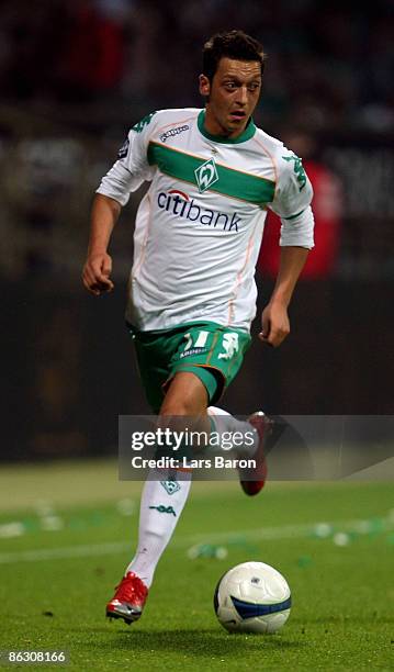 Mesut Oezil of Bremen runs with the ball during the UEFA Cup Semi Final first leg match between SV Werder Bremen and Hamburger SV at the Weser...