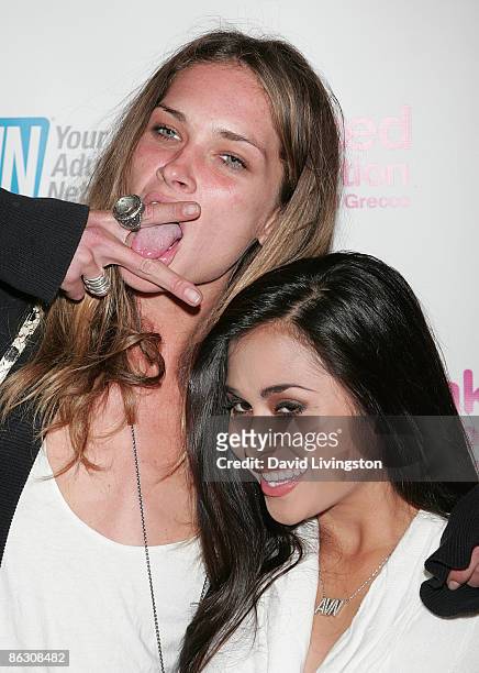 Model Erin Wasson poses with adult film actress/AVN correspondent Michelle Maylene outside Laemmle's Sunset 5 on April 30, 2009 in West Hollywood,...