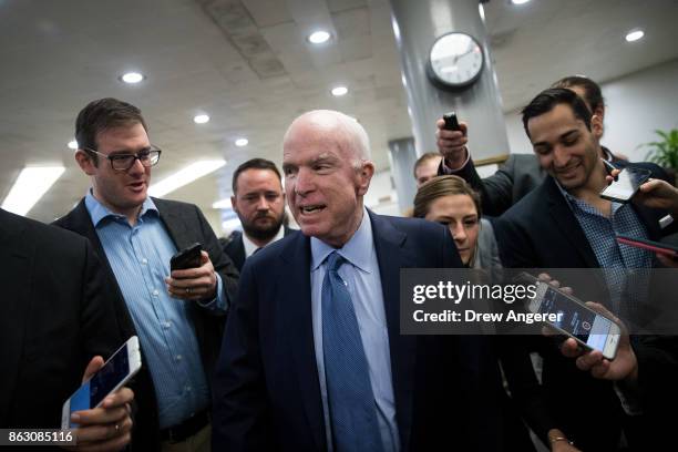 Sen. John McCain talks to reporters as he heads to a vote on amendments to the fiscal year 2018 budget resolution, on Capitol Hill, October 19, 2017...