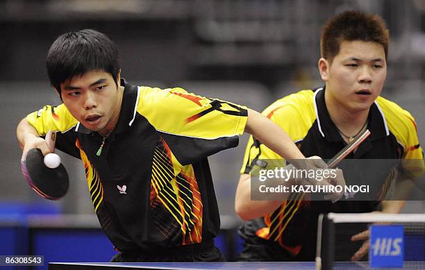 Taiwan's Chuang Chih-Yuan serves the ball as his partner Wu Chih-Chi looks on during their men's doubles second round match against Japan's Kenji...