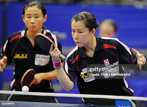 Austria's Li Qiangbing returns the ball as her partner Liu Jia looks on during their women's doubles second round match against Hong Kong's Lin Ling...