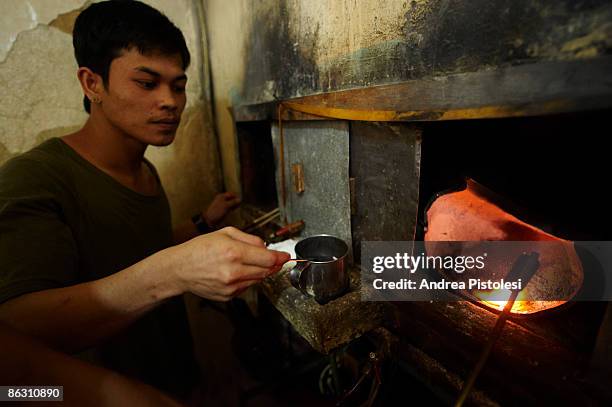 Extracting pure gold from the mined and processed rock in the mining settlement of Barangay, on Mount Diwata , Compostela Valley, on Mindao Island in...