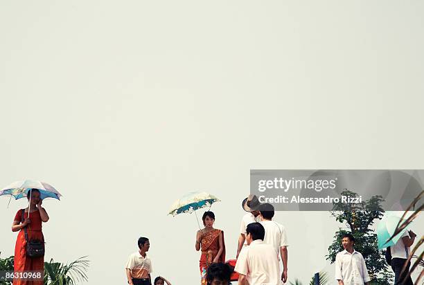 Local people walk toward the Mekong river, centre of the public holiday. Each year, the Dai ethnic minority from southern China celebrate the start...