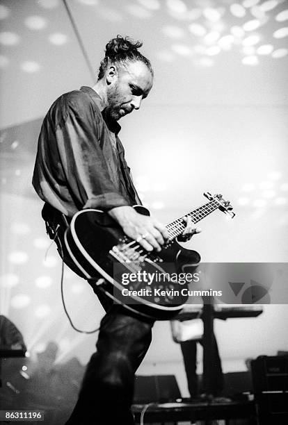 Bassist Peter Hook performing with English rock group New Order at the GMEX centre , Manchester, during the Festival Of The 10th Summer, 19th July...