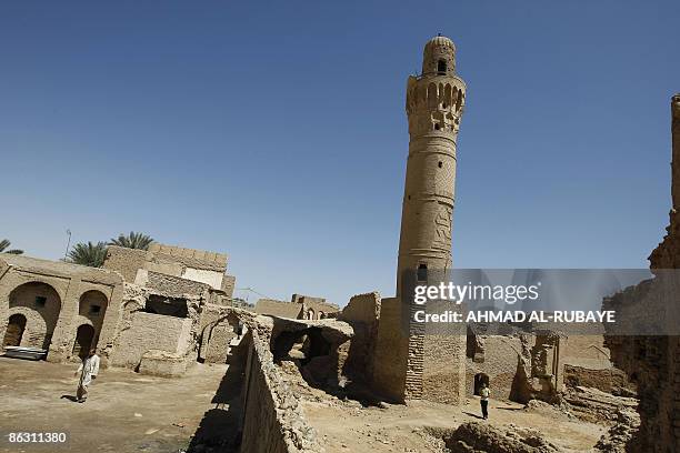 The 14th-century brick minaret of the Dhu al-Kifl mosque tilts outside the entrance to the Jewish shrine of Ezekiel -- the prophet who followed the...