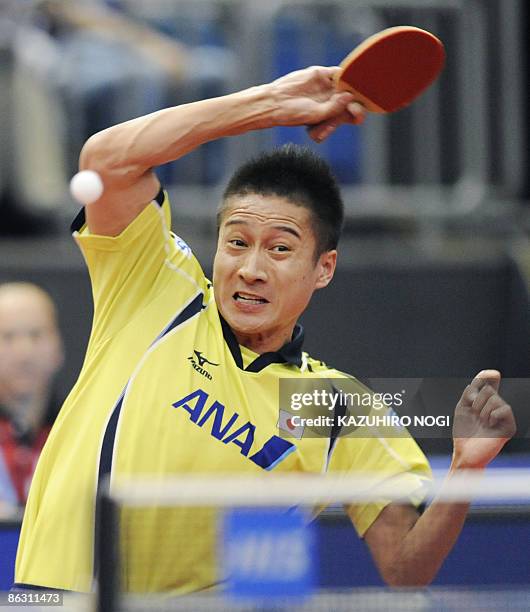 Japan's Kaii Yoshida returns the ball against Bojan Tokic of Slovenia during their men's singles third round match in the World Table Tennis...