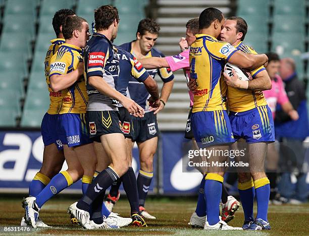 Luke Burt of the Eels is congratulated by his team mates after scoring a try during the round eight NRL match between the Parramatta Eels and the...