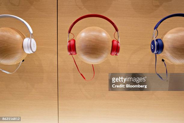 Beats by Dre headphones hang on display during a media preview of the new Apple Inc. Michigan Avenue store in Chicago, Illinois, U.S., on Thursday,...