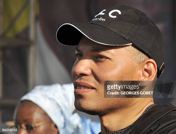 Picture taken on March 20, 2009 shows Karim Wade, son of Senegal president Abdoulaye Wade, listening to his father speaking at a local election...