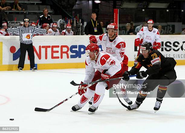 Alexander Barta of Germany fights for the puck with Jesper Daamgard and Mads Christensen of Denmark during the IIHF World Ice Hockey Championship...