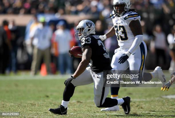 DeAndre Washington of the Oakland Raiders carries the ball against the Los Angeles Chargers during an NFL football game at Oakland-Alameda County...