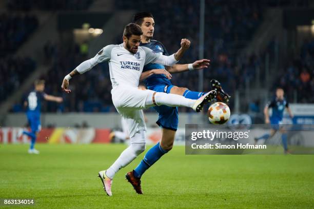 Benjamin Huebner of Hoffenheim is tackled by Junior Caicara of Istanbul during the UEFA Europa League group C match between 1899 Hoffenheim and...