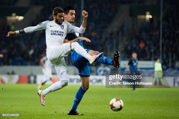 Benjamin Huebner of Hoffenheim is tackled by Junior Caicara of Istanbul during the UEFA Europa League group C match between 1899 Hoffenheim and...