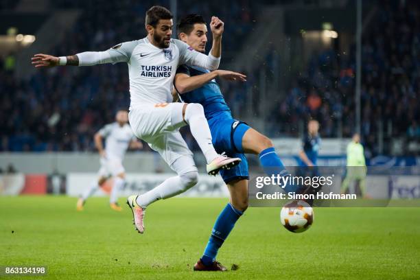 Benjamin Huebner of Hoffenheim is tackled by Junior Caicara of Istanbul during the UEFA Europa League group C match between 1899 Hoffenheim and...