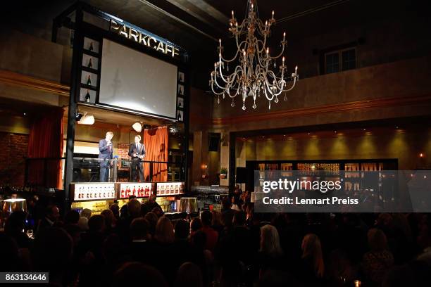 Presenter Rudi Cerne and producer Martin Gross speak during the 'Aktenzeichen XY... Ungeloest' 50th anniversary celebration at Park Cafe on October...