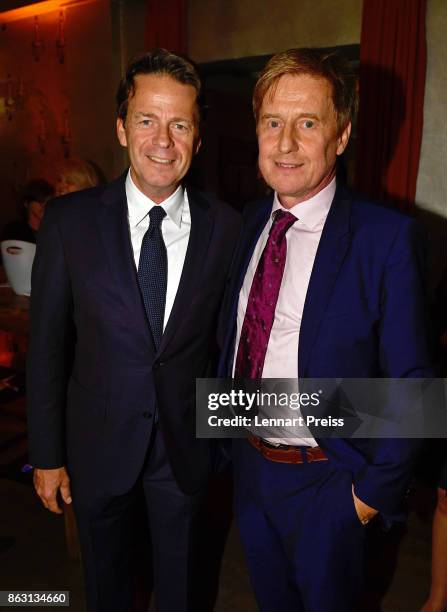 Presenter Rudi Cerne and producer Martin Gross pose during the 'Aktenzeichen XY... Ungeloest' 50th anniversary celebration at Park Cafe on October...