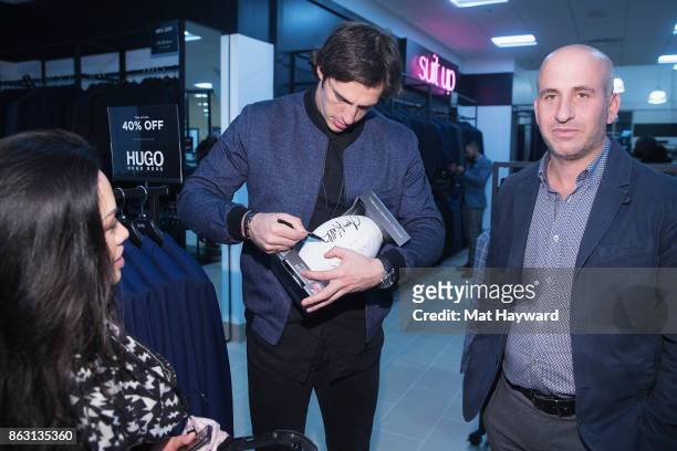 Seattle Seahawks Tight End Luke Willson signs an autograph for a fan during the Saks OFF 5TH Seattle VIP Grand Opening Party on October 18, 2017 in...