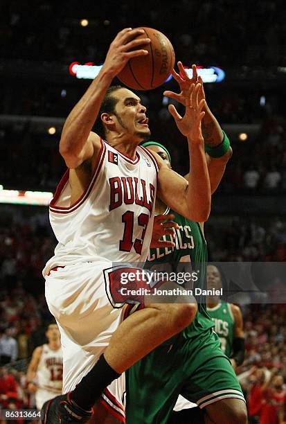 Joakim Noah of the Chicago Bulls goes up for a dunk against Paul Pierce of the Boston Celtics in Game Six of the Eastern Conference Quarterfinals...