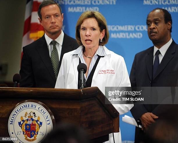 Maryland Governor Martin O'Malley and Montgomery County Executive Isiah Leggett listen to remarks by Deputy State Health Secretary Dr. Fran Phillips...