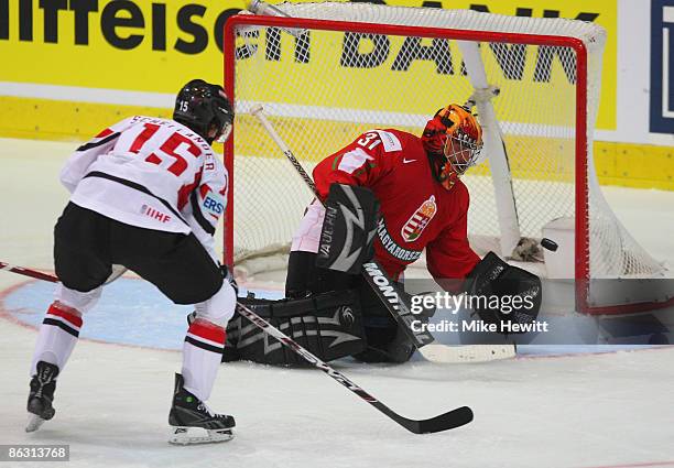 Levente Szuper of Hungary makes a save from Paul Schellander of Austria during the IIHF World Championship match between Austria and Hungary at the...