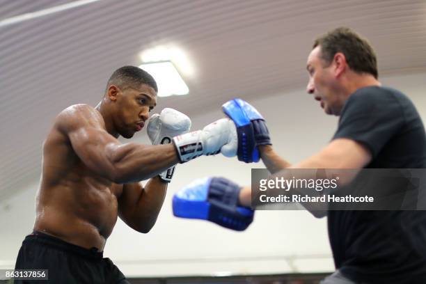 Anthony Joshua works out with his trainer Rob McCracken during a media workout at the English Institute of Sport on October 17, 2017 in Sheffield,...