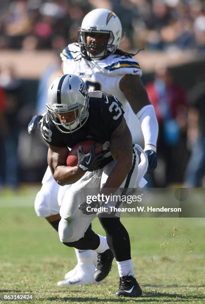 DeAndre Washington of the Oakland Raiders carries the ball against the Los Angeles Chargers during an NFL football game at Oakland-Alameda County...