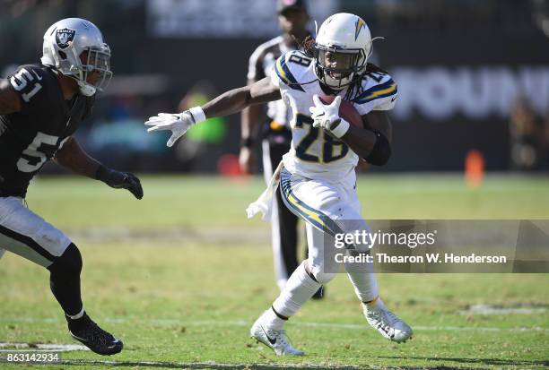Melvin Gordon of the Los Angeles Chargers fights off the tackle of Bruce Irvin of the Oakland Raiders during an NFL football game at Oakland-Alameda...