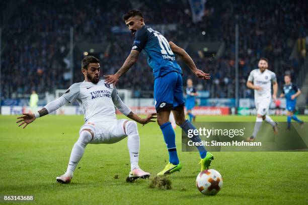 Kerem Demirbay of Hoffenheim is tackled by Junior Caicara of Istanbul during the UEFA Europa League group C match between 1899 Hoffenheim and...